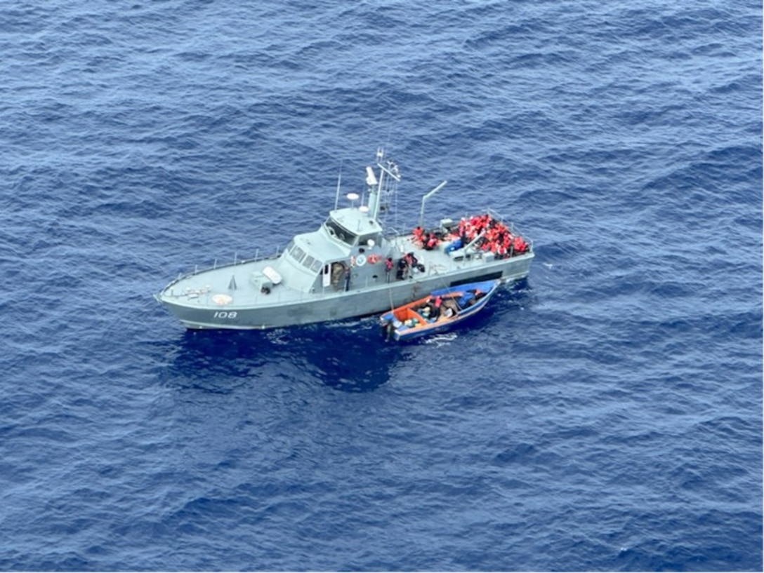 Photo taken from a responding Coast Guard MH-60T Jayhawk helicopter of a Dominican Republic Navy patrol boat on-scene with a disabled migrant vessel in Mona Passage waters off the Dominican Republic, Jan. 31, 2024. The Coast Guard helicopter aircrew located the disabled vessel, while the Dominican Republic Navy arrived on-scene and safely rescued 33 migrants, who were then returned to the Dominican Republic.  (U.S. Coast Guard photo)