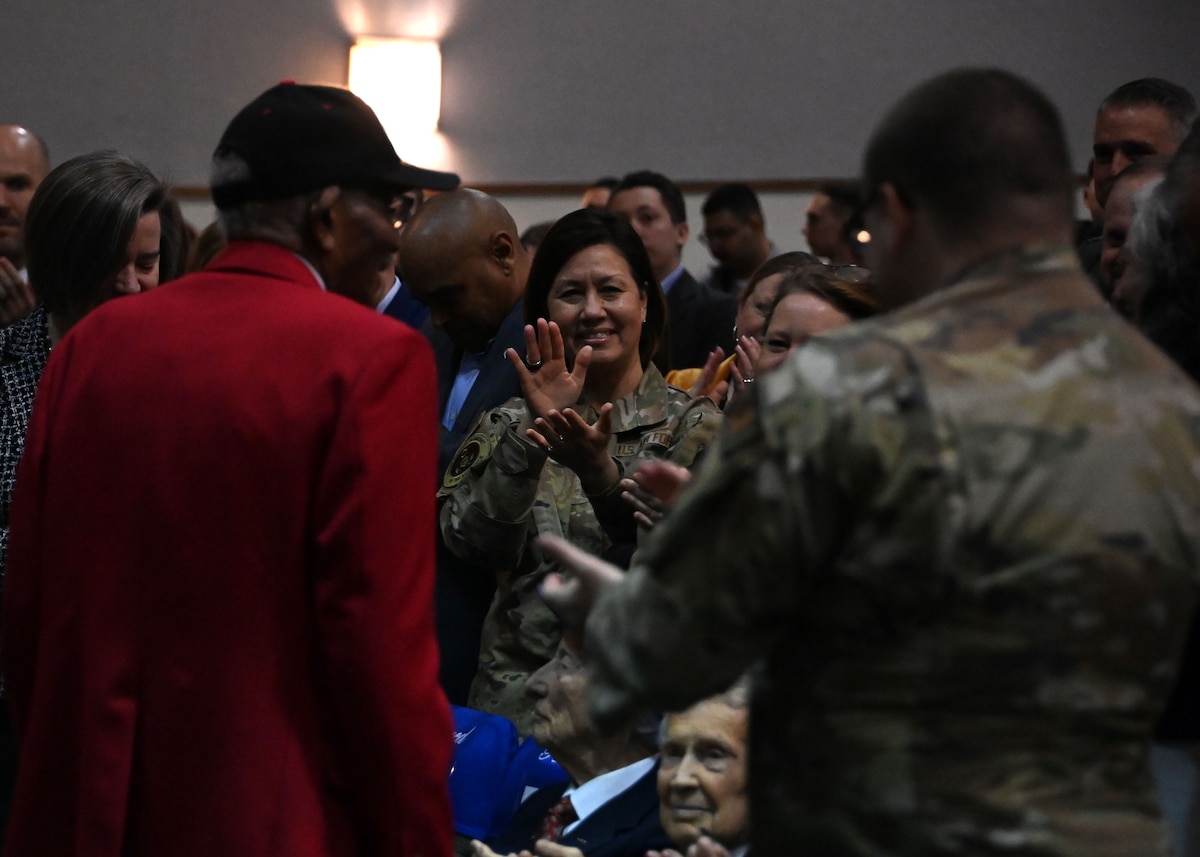 Retired Sgt. Thomas Newton, a Tuskegee Airman, receives a standing ovation during a “Masters of the Air” special screening at Joint Base Andrews, Md.