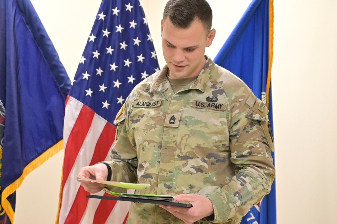 Sgt. 1st Class Paul Almquist, a range operations noncommissioned officer with the Fort Indiantown Gap Training Center, receives an award for his volunteer work with Big Brothers Big Sisters of the Capital Region during a ceremony at Fort Indiantown Gap, Pennsylvania, Jan. 30, 2024. Almquist has volunteered with that organization for eight years, impacting children’s lives. Deborah Wright, director of Lebanon and Lancaster counties presented the award on behalf of Big Brothers Big Sisters. (U.S. Army National Guard photo by 2nd Lt. Kate Kramer)