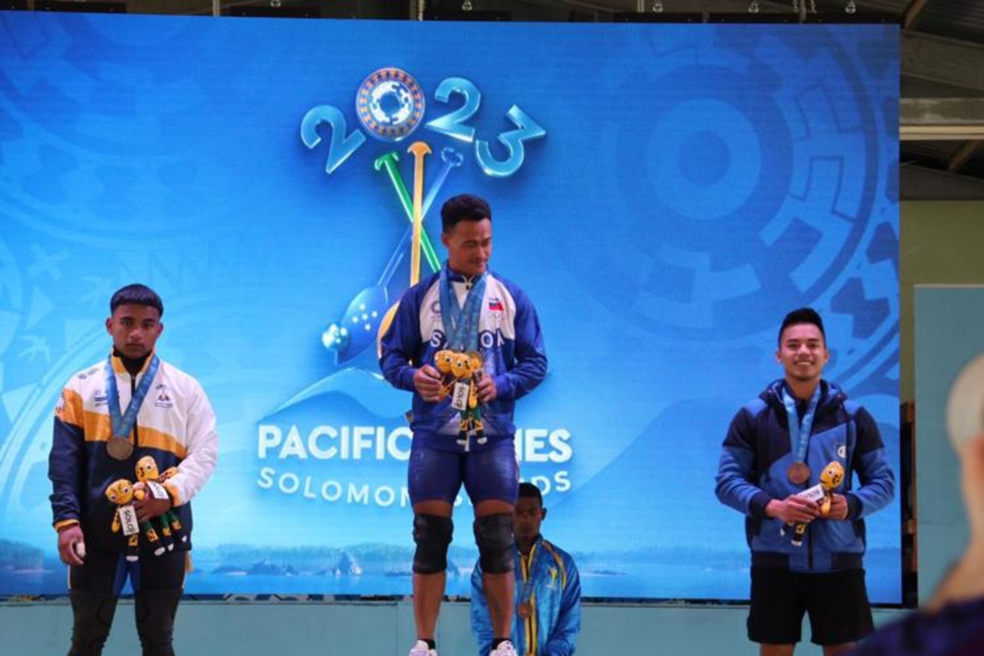 A photo of weightlifters on podium