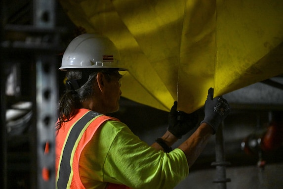 A member in support of Joint Task Force-Red Hill (JTF-RH) prepares a tarp as a safety precaution for residual fuel removal at the Red Hill Bulk Fuel Storage Facility (RHBFSF) Jan. 22, 2024, Halawa, Hawaii.