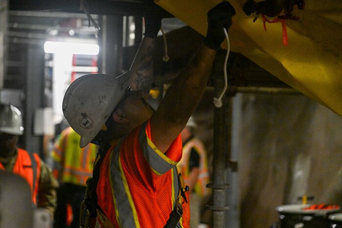 A member in support of Joint Task Force-Red Hill (JTF-RH) prepares a tarp as a safety precaution for residual fuel removal at the Red Hill Bulk Fuel Storage Facility (RHBFSF) Jan. 22, 2024, Halawa, Hawaii.