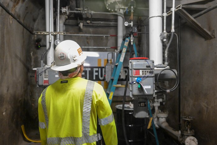 A member in support of Joint Task Force-Red Hill (JTF-RH) observes a drainage line defueling residual fuel from the Red Hill Bulk Fuel Storage Facility (RHBFSF) Jan. 30, 2024, Halawa, Hawaii.