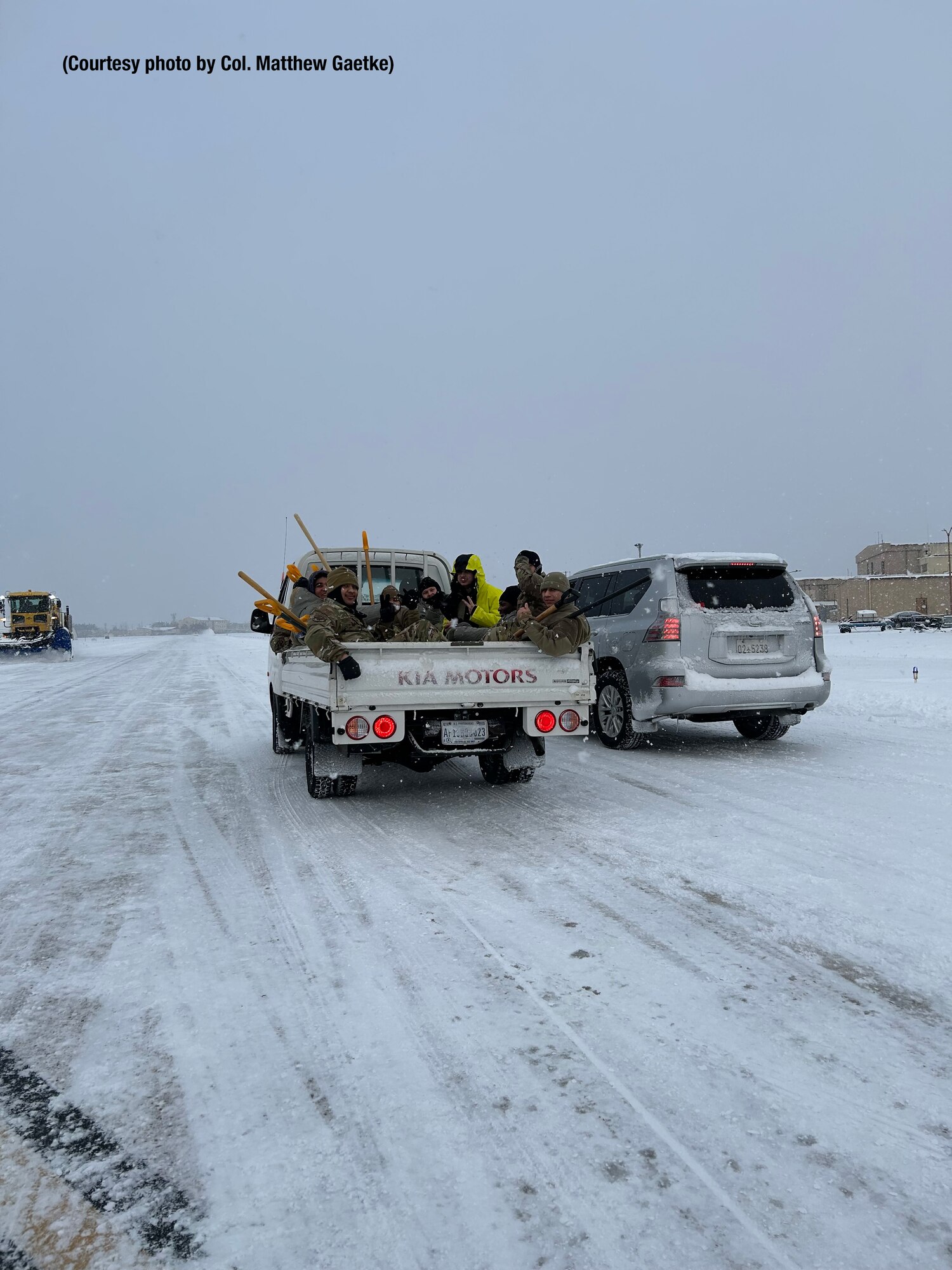 Airmen shoveling snow.