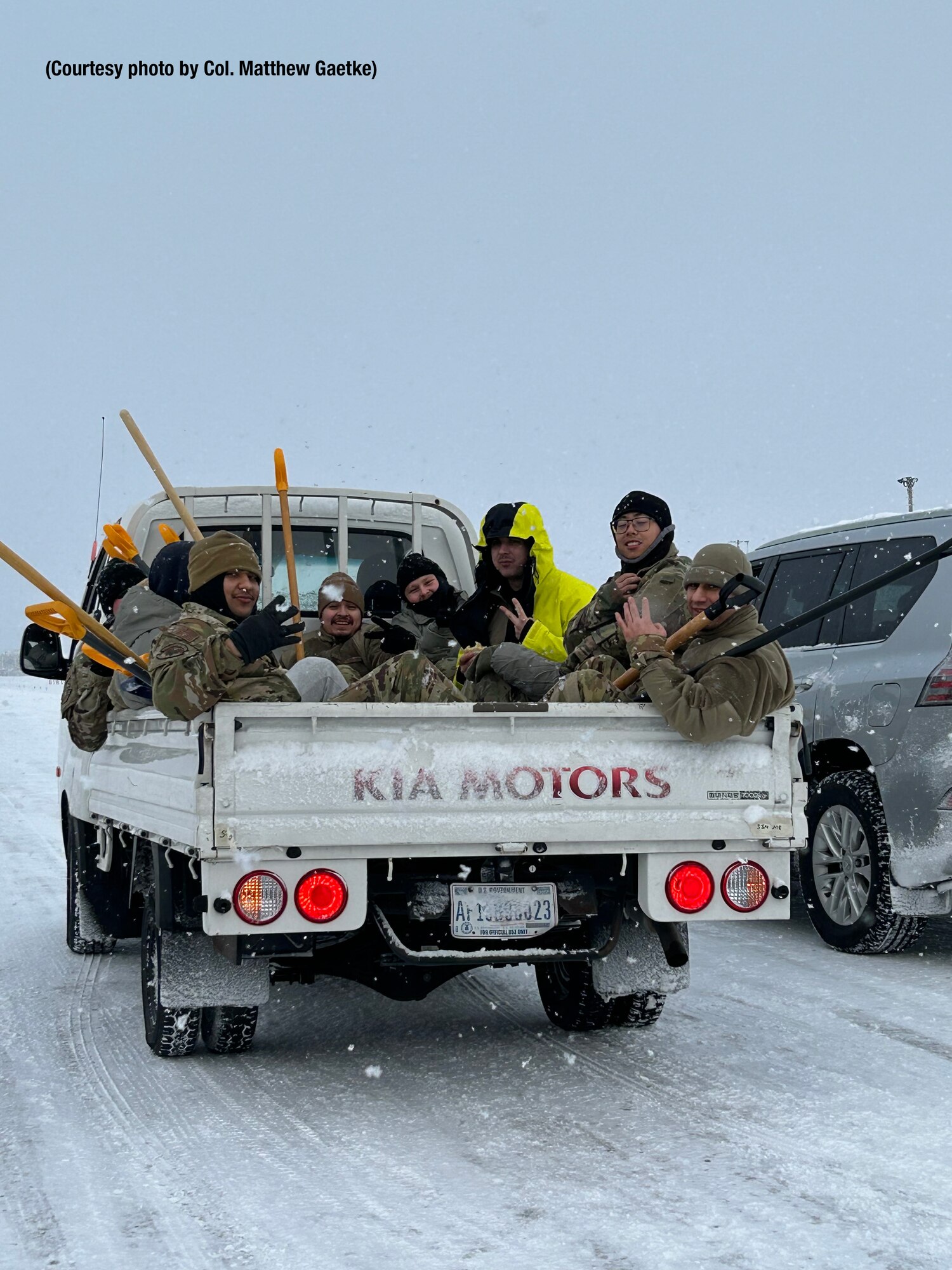 Airmen shoveling snow.
