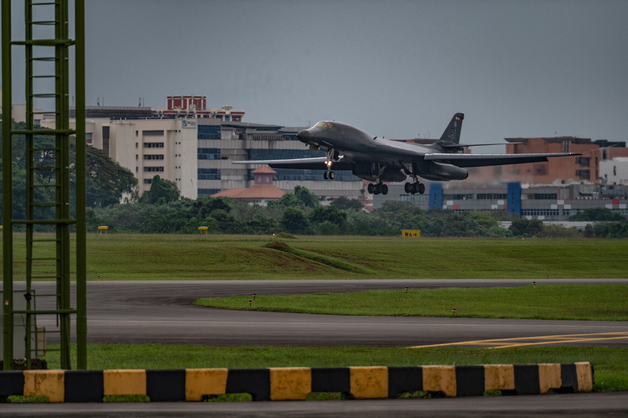 A B-1B Lancer assigned to the 345th Expeditionary Bomb Squadron, out of Dyess Air Force Base, Texas, prepares to land at Paya Lebar Air Base, Singapore, Jan. 19, 2024. The 345th EBS arrived in Singapore as part of regular U.S. Air Force training and engagements with key partners in the region. (U.S. Air Force Photo by Senior Airman Ryan Hayman)