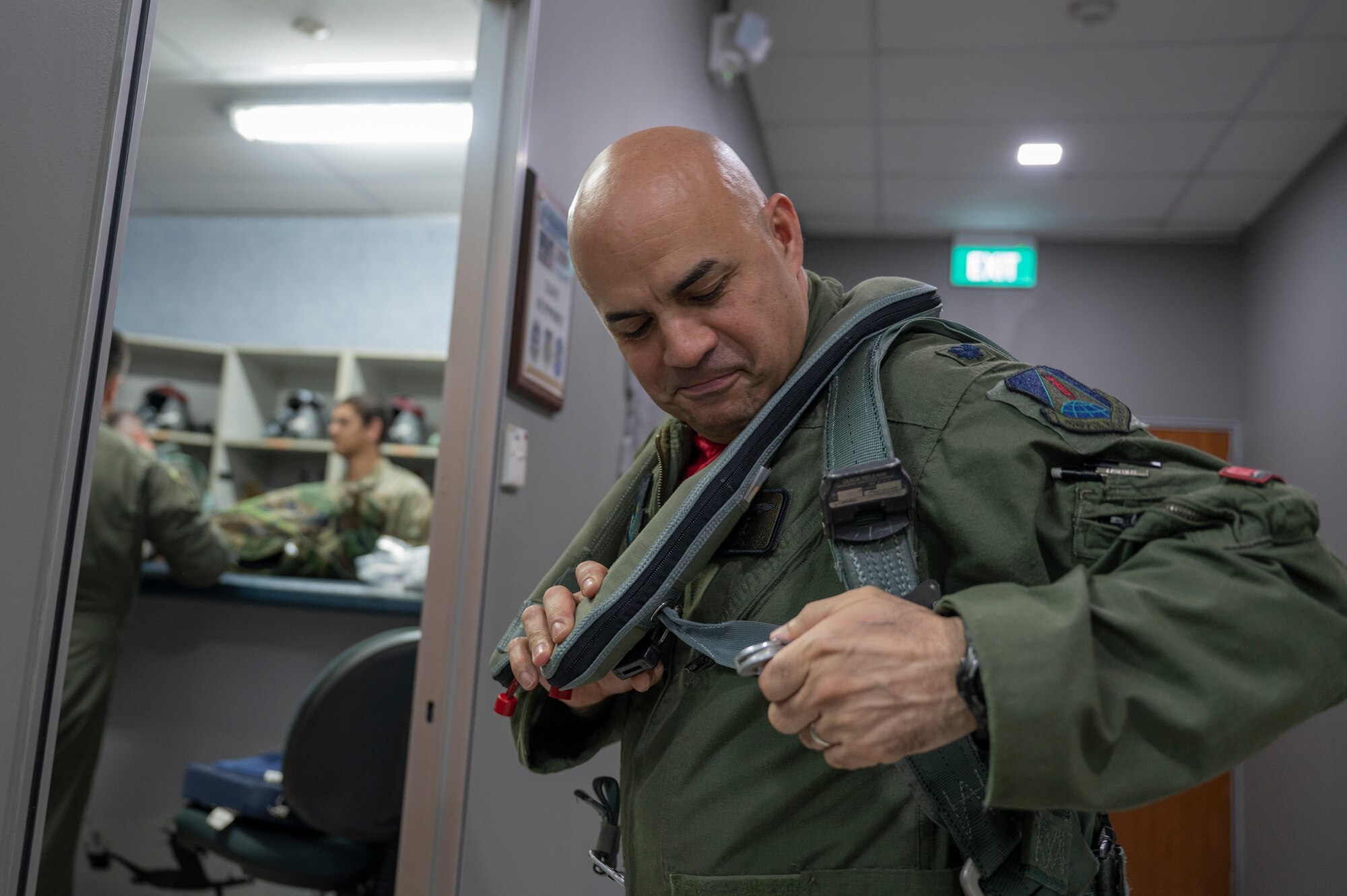 U.S. Air Force Lt. Col. Eric Alvarez, 345th Expeditionary Bomb Squadron commander, out of Dyess Air Force Base, Texas, puts on his vest at Paya Lebar Air Base, Singapore, Jan. 19, 2024. The B-1B Lancer conducted air-to-air refueling with the Republic of Singapore Air Force A330 Multi Role Tanker Transport. (U.S. Air Force Photo by Senior Airman Ryan Hayman)