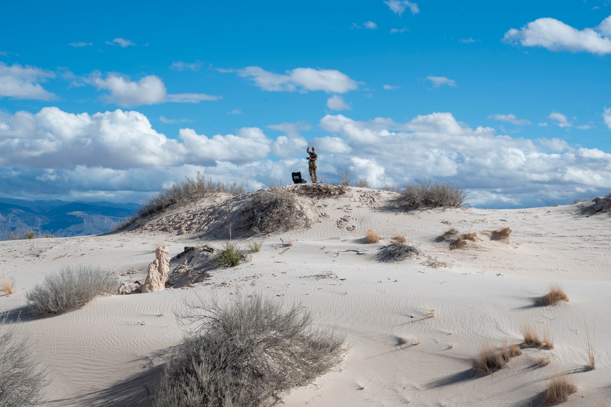 U.S. Air Force Airman Melody Kaiser, 54th Operations Support Squadron weather apprentice, poses for a photo during an exercise at Holloman Air Force Base, New Mexico, Jan. 22, 2024. The team conducted their first-time exercise in sand dunes on the installation to better understand the desert conditions in the areas surrounding Holloman. Many of the unique environmental factors in the environment here could influence the 49th Wing’s mission. (U.S Air Force photo by Airman 1st Class Isaiah Pedrazzini)