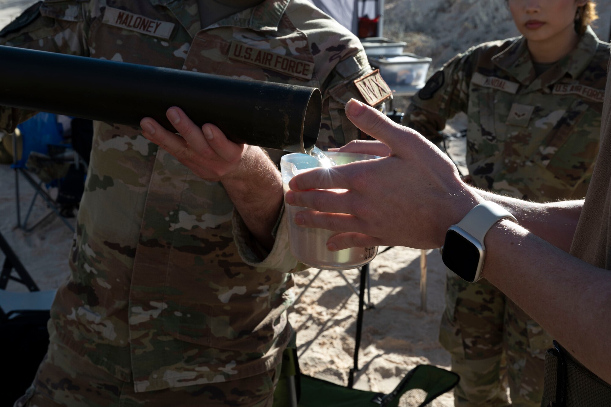 Members of the 54th Operations Support Squadron weather flight pour water on a sand sample for measurements during an exercise at Holloman Air Force Base, New Mexico, Jan. 22, 2024. The team conducted their first time exercise in sand dunes on the installation to better understand the desert conditions in the areas surrounding Holloman. Many of the unique environmental factors in the environment here could influence the 49th Wing’s mission. (U.S Air Force photo by Airman 1st Class Isaiah Pedrazzini)