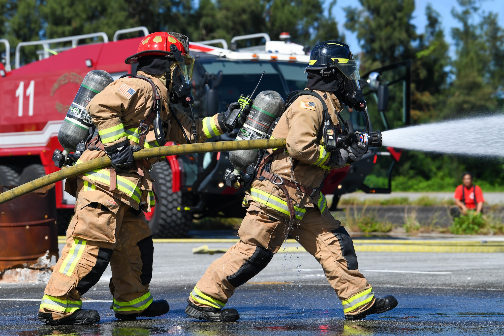 two Kadena firefighters press foward during a aircraft rescue training exersise