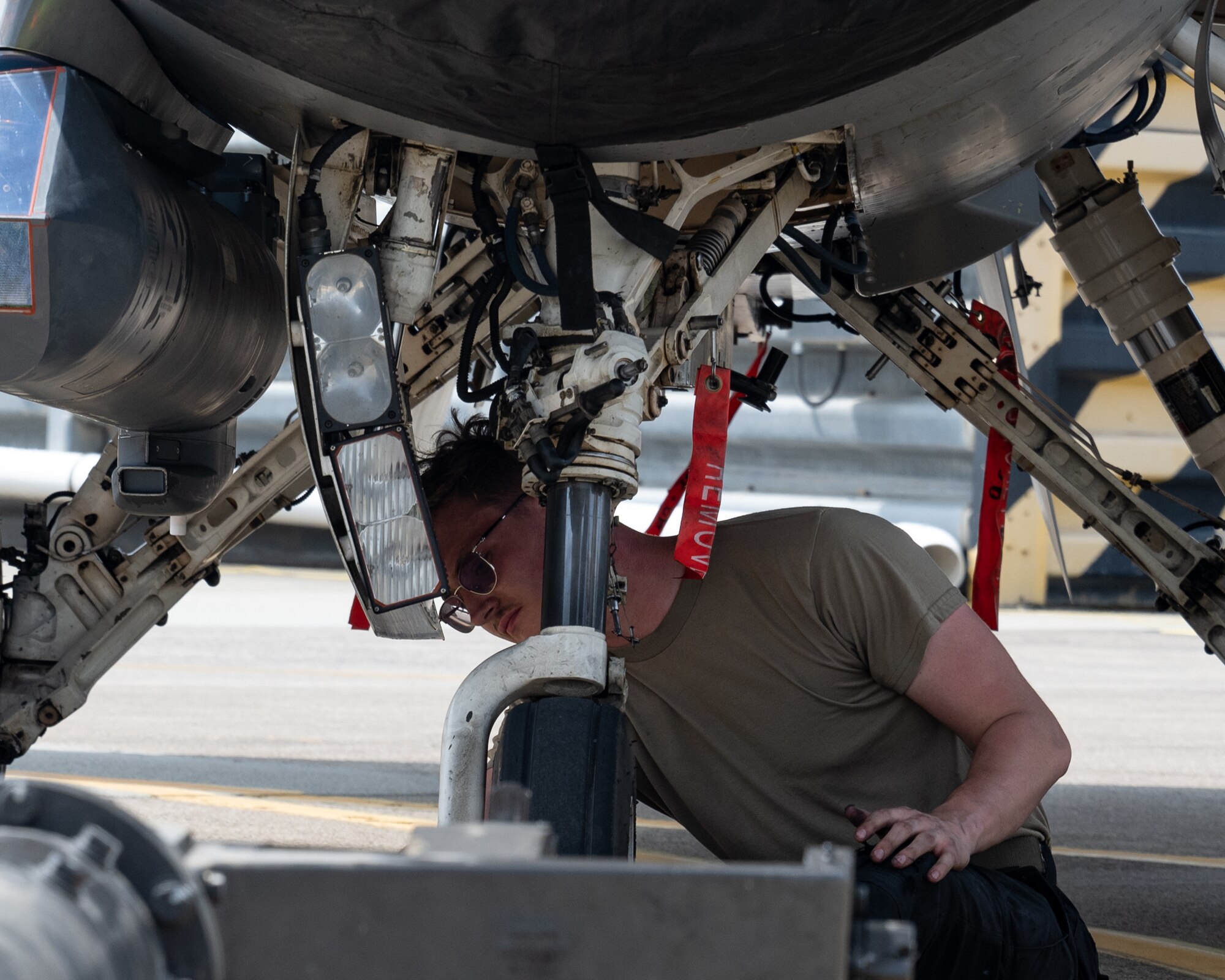 Airman Layne Veldhuizen, 80th Fighter Generation Squadron crew chief, performs post-flight checks on F-16 Fighting Falcon landing gear struts during Buddy Squadron 24-4 at Cheongju Air Base, Republic of Korea.