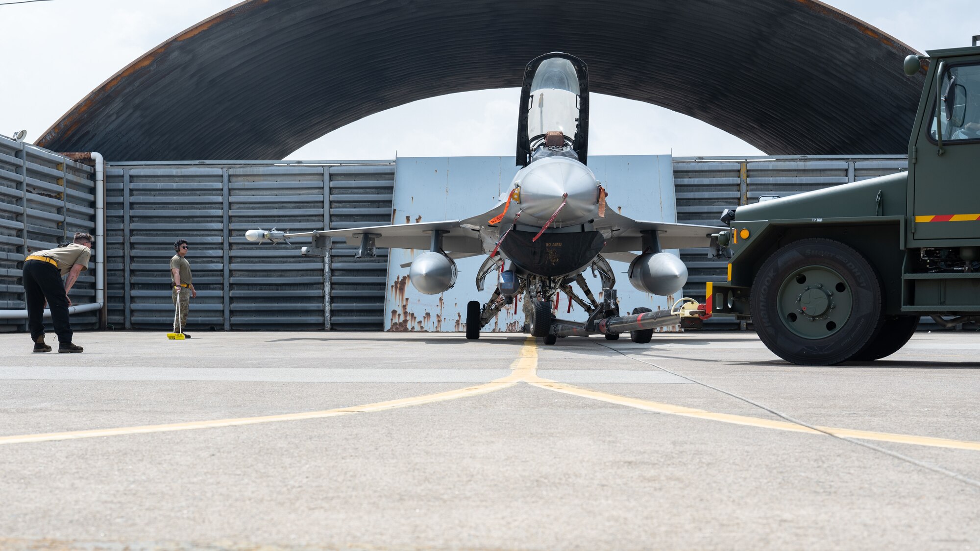 An F-16 Fighting Falcon aircraft, assigned to the 80th Fighter Squadron, is towed into a parking spot at Cheongju Air Base, Republic of Korea.