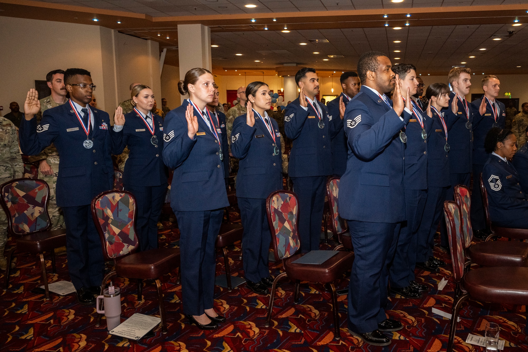 U.S. Airmen recite the charge to the noncommissioned officer during a NCO induction ceremony at Royal Air Force Mildenhall, England, June 27, 2024.