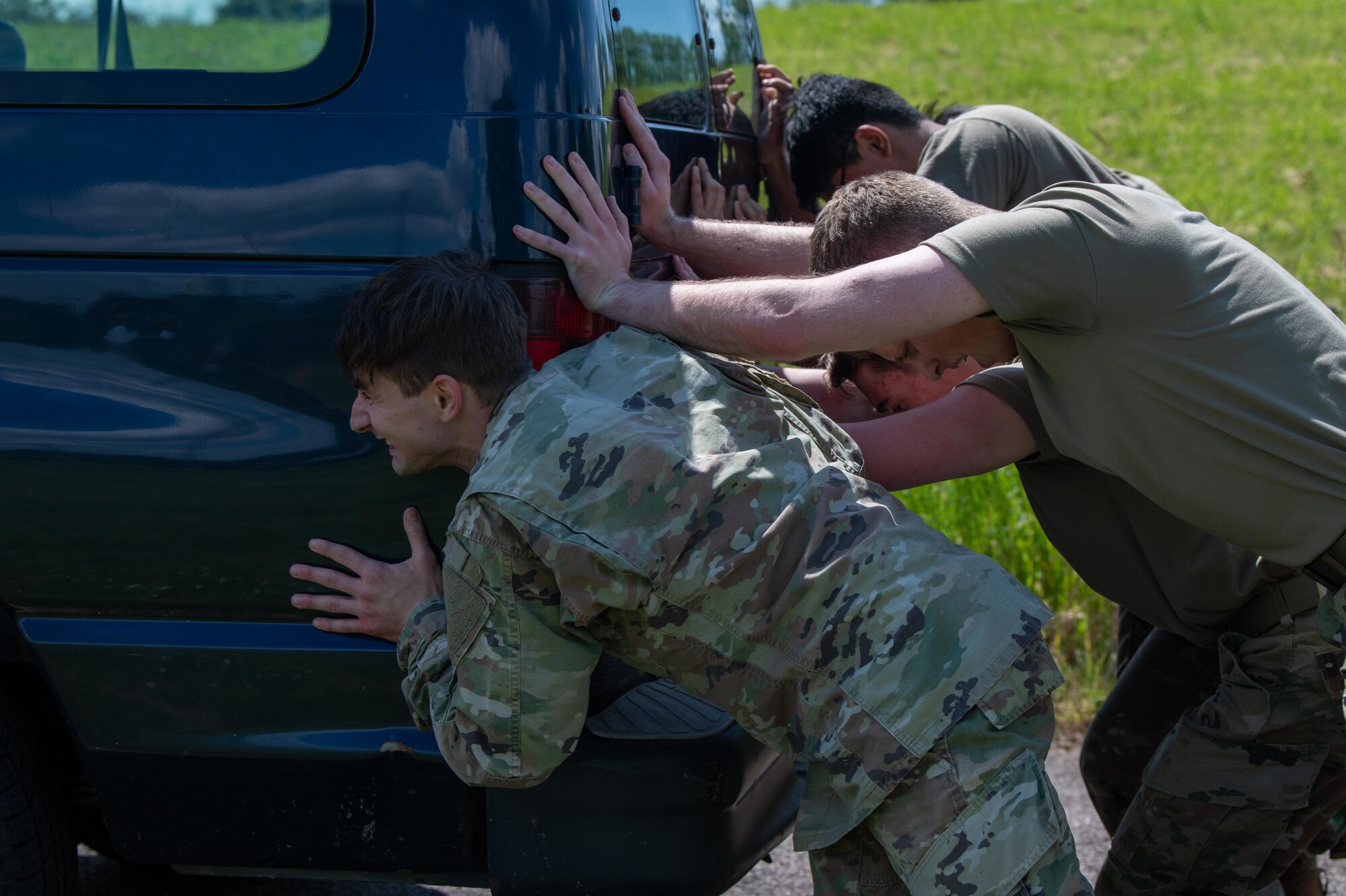 Airmen push a van