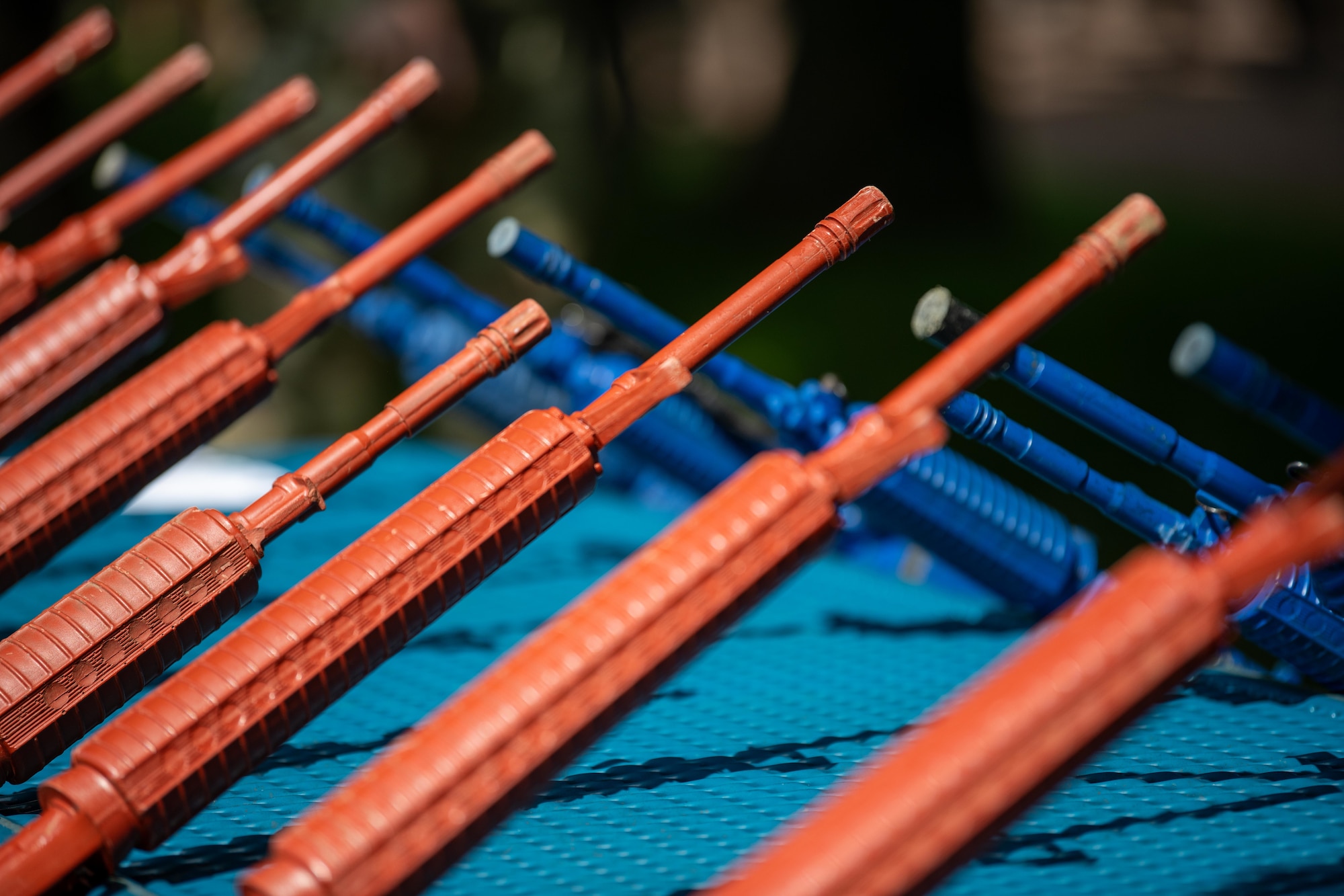 Training weapons lean against a table