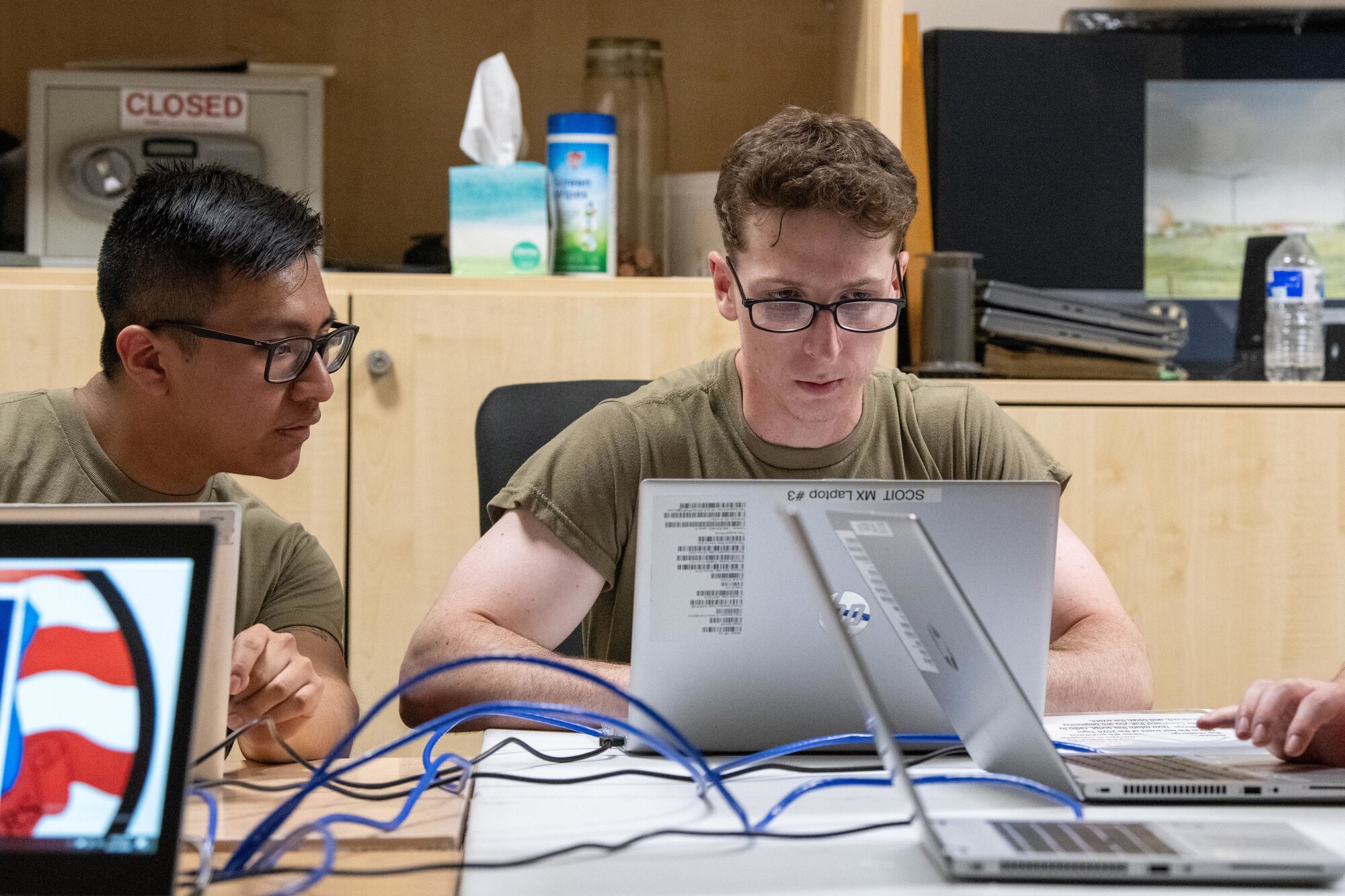 Airmen test a laptop circuit with a ping test during a Tiger Challenge