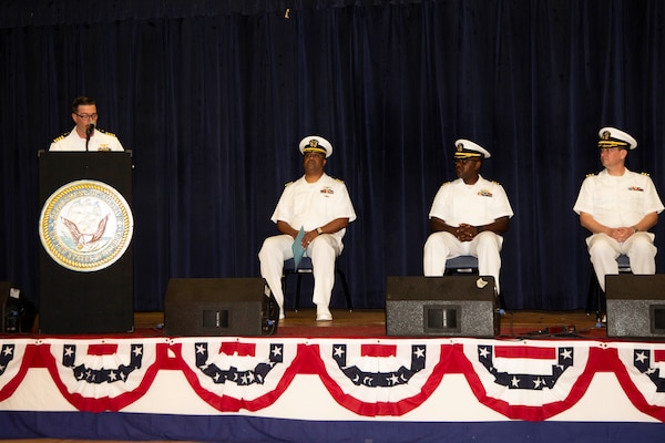 DIEGO GARCIA, British Indian Ocean Territory – Capt. Pete J. Hatcher, commanding officer of U.S. Naval Support Facility (NSF) Diego Garcia, speaks in front of Capt. Richard Gilliard, executive officer of U.S. Navy Medicine Readiness and Training Command Yokosuka Japan, Cmdr. Clifton Butler, outgoing officer in charge at Naval Medical Readiness Training Unit (NMRTU) Diego Garcia, and Cmdr. Kenneth Jenkins, incoming officer in charge for NMRTU Diego Garcia, during the NMRTU Diego Garcia change of charge ceremony onboard NSF Diego Garcia June 24, 2024. NSF Diego Garcia’s mission is to provide critical support to U.S. and allied forces forward deployed to the Indian Ocean, while supporting multi-theater forces operating in the CENTCOM, AFRICOM, EUCOM and PACOM areas of responsibilities in support of overseas contingency operations. (Courtesy photo by Nengh Dumlao)