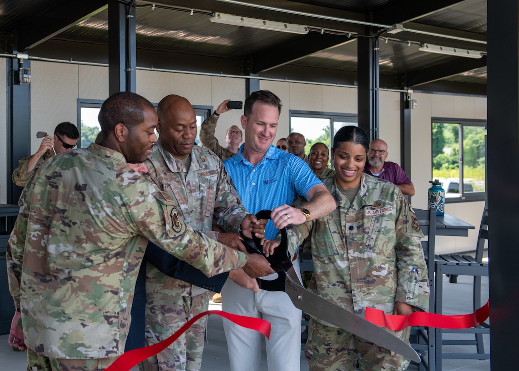 Col. Todd E. Randolph and members of the 316th Force Support Squadron cut the ribbon at the Toptracer ribbon-cutting ceremony.