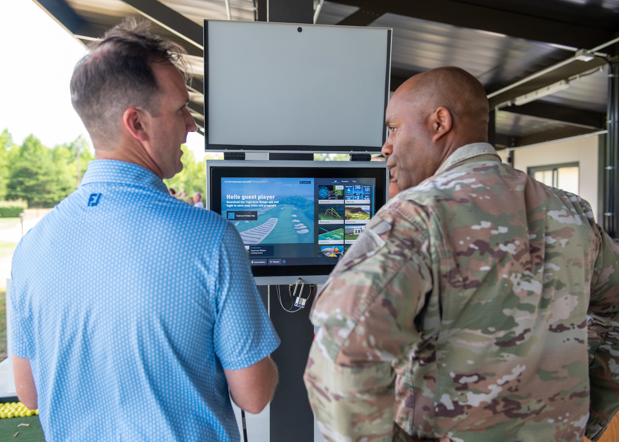 Steve Dobson explaining to Col. Todd E. Randolph how the Toptracer technology works.