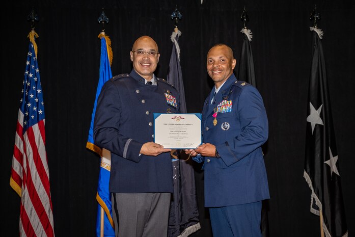 Lt. Gen. David Miller Jr., Space Operations Command commander, presents Col. Marqus Randall, outgoing Delta 18 - National Space Intelligence Center commander, with the Legion of Merit award during a change of command ceremony at Wright-Patterson Air Force Base, Ohio, June 28, 2024. The historic event was the first NSIC change of command ceremony as well as the activation of the unit as a field operating agency reporting directly to headquarters U.S. Space Force. (U.S. Air Force photo by Daniel Peterson)