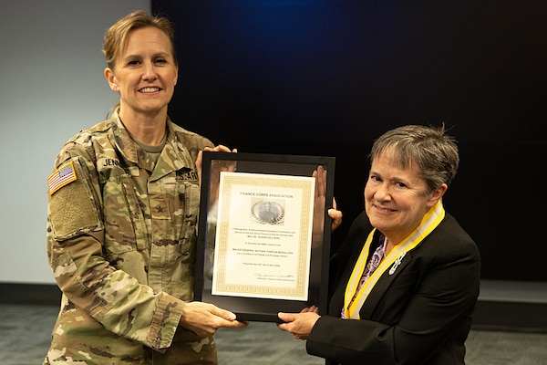 Brig. Gen. Paige M. Jennings, U.S. Army Financial Management Command commanding general, presents Susan Gillison, USAFMCOM Military Pay Operations director, with a Maj. Gen. Nathan Towson Medallion during an Army Military Pay Office leadership forum at the Maj. Gen. Emmett J. Bean Federal Center in Indianapolis June 14, 2024. The medallion is awarded to honor Towson, a two-time Army paymaster general in the early 1800s, and recognizes those who demonstrate exemplary contribution and service to the U.S. Army Finance Corps. (U.S. Army photo by Brad Staggs)