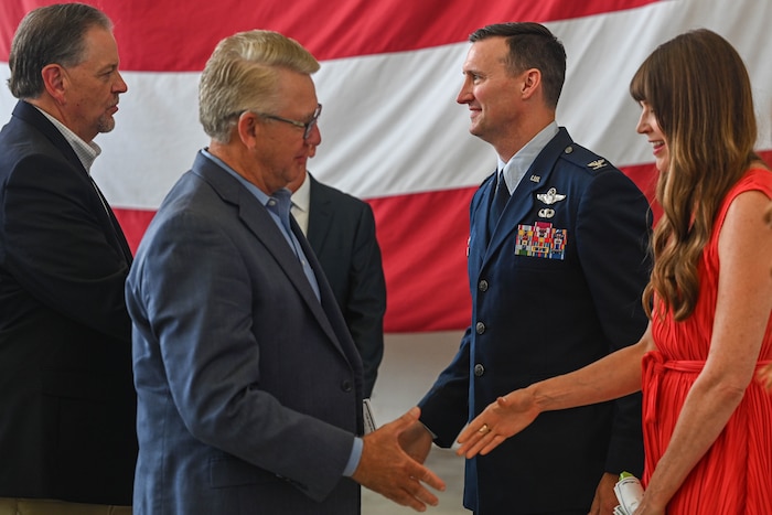 People shake hands with the wing commander