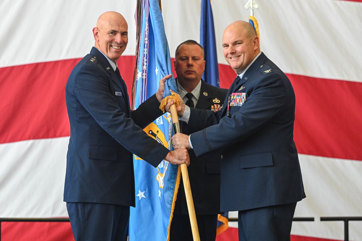U.S. Military officers pass a guidon
