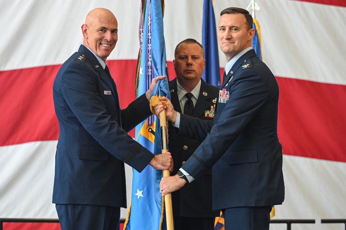 U.S. Military officers pass a guidon