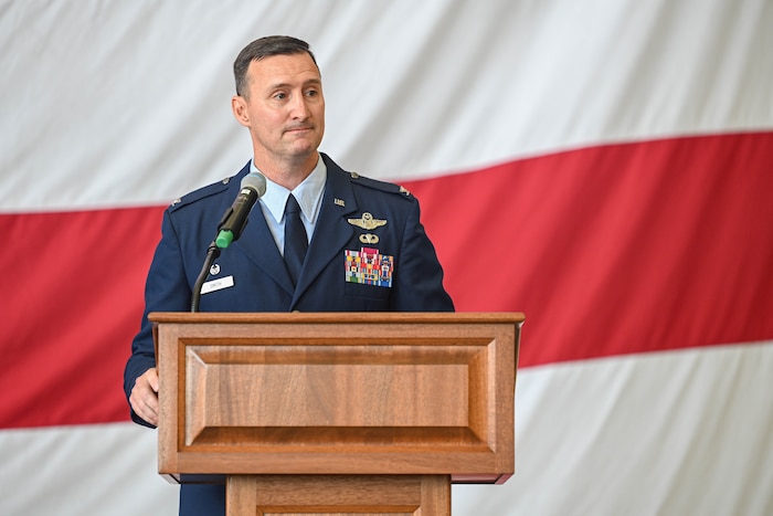 A commander speaks at a lectern