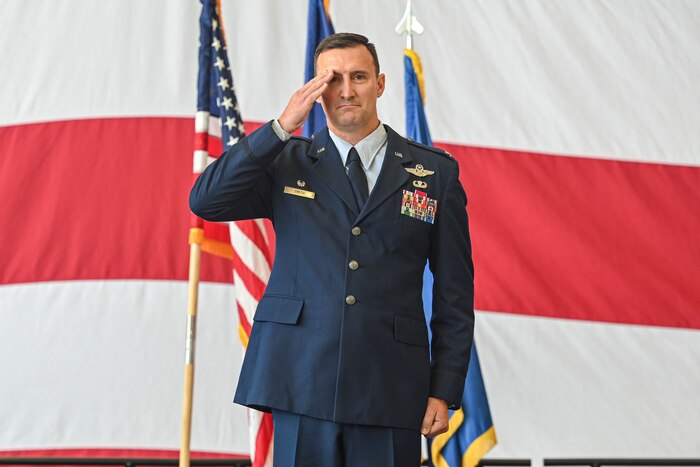 A commander salutes at attention