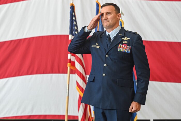 A commander salutes at attention