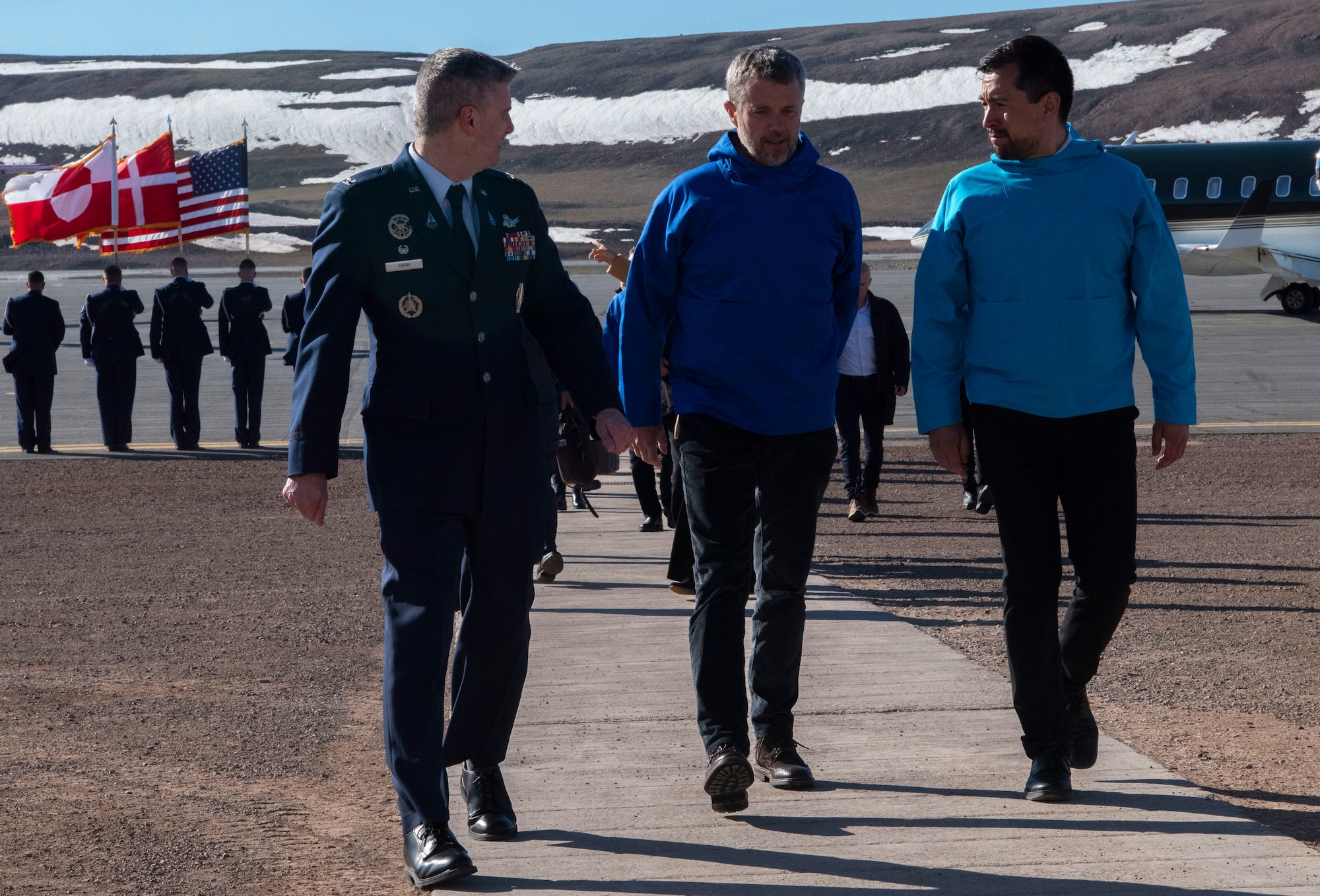 From the left, U.S. Space Force Col. Jason Terry, 821st Space Base Group commander, King Frederik X, King of the Kingdom of Denmark, and Múte Bourup Egede, Prime Minister of Greenland, enjoy a discussion on their way inside after King Frederik X’s arrival to Pituffik Space Base, Greenland. June 29, 2024. King Frederik X made a stop to Pituffik SB while on his way to the village of Qaanaaq. (U.S. Space Force photo by 1st Lt. Danielle Rose)