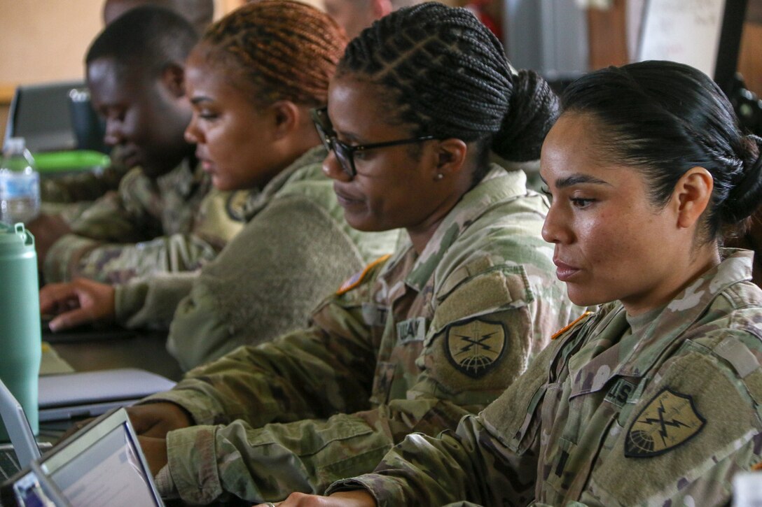 Soldiers working at their laptops