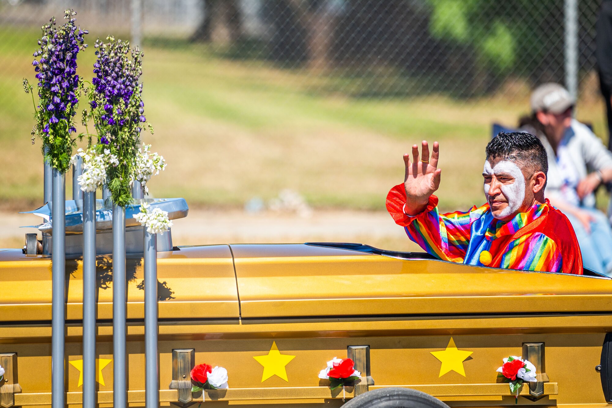 A participant dressed as a clown drives a vehicle during the Lompoc Flower Festival Parade in Lompoc, Calif., June 22, 2024. Leadership from U.S. Space Forces - Space and Space Launch Delta 30 participated in the parade which had over 50 entrees and 500 attendees. (U.S. Space Force photo by Tech. Sgt. Luke Kitterman)