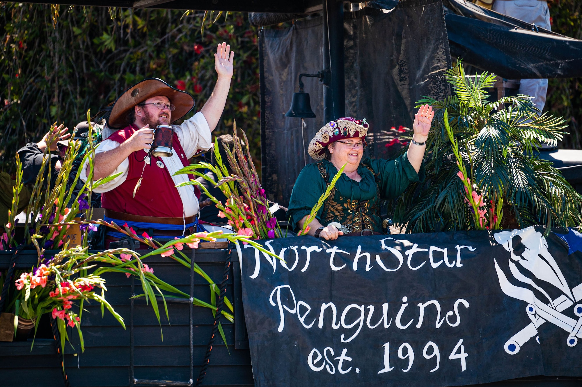 Participants on a pirate ship float wave to the crowd during the Lompoc Flower Festival Parade in Lompoc, Calif., June 22, 2024. Leadership from U.S. Space Forces - Space and Space Launch Delta 30 participated in the parade which had over 50 entrees and 500 attendees. (U.S. Space Force photo by Tech. Sgt. Luke Kitterman)