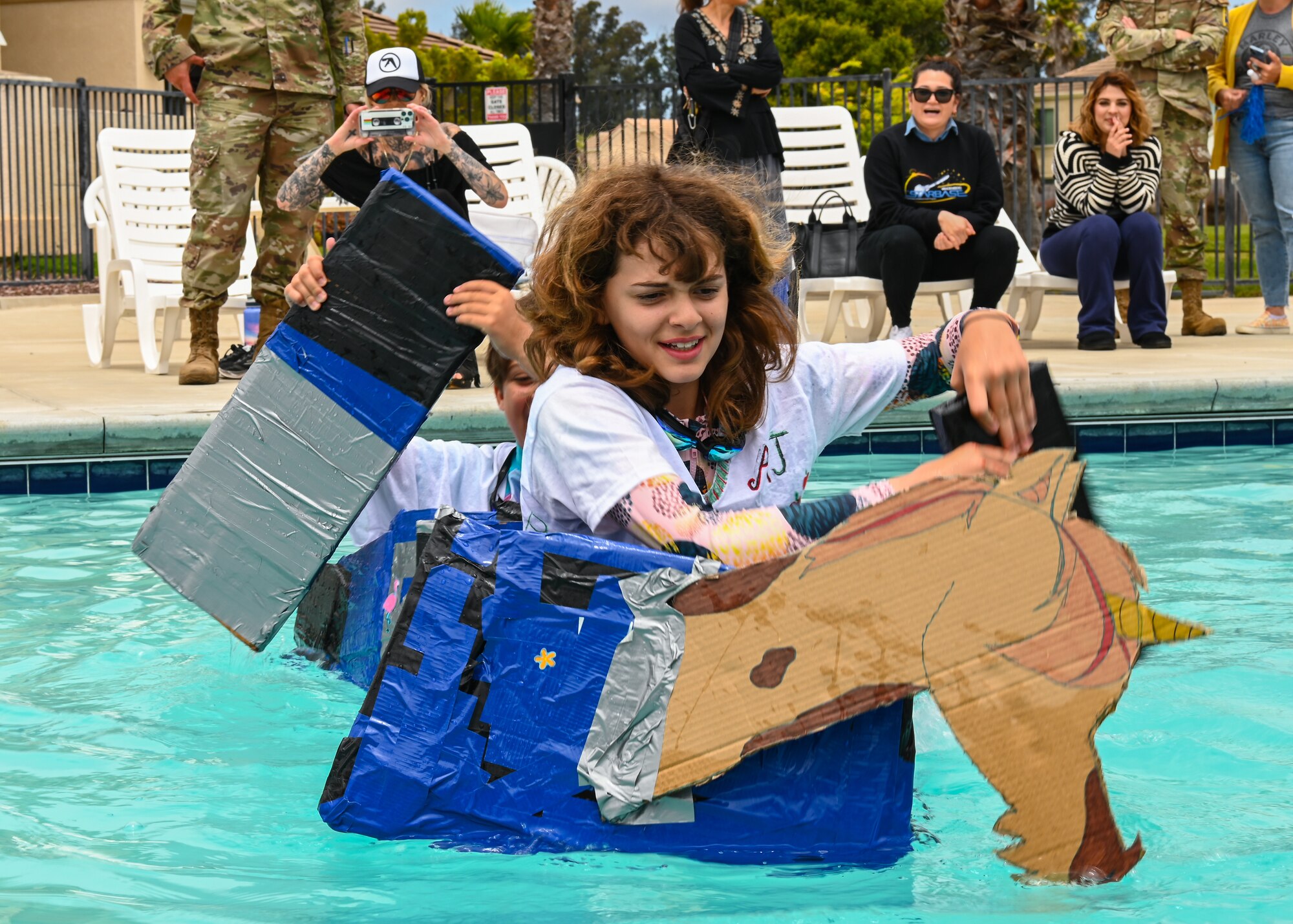 Children participate in the 30th Force Support Squadron Youth Program Jr. Cardboard Boat Regatta at Vandenberg Space Force Base.