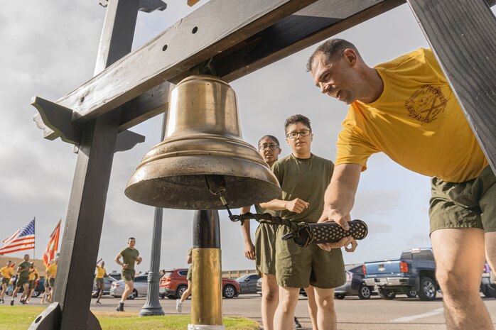 U.S. Marine Corps Lt. Col. James R. R. Smith, commanding officer, 2nd Recruit Training Battalion, Recruit Training Regiment, rings the liberty bell during a motivational run for Echo Company, 2nd Recruit Training Battalion at Marine Corps Recruit Depot San Diego, California, June 27, 2024 The company motivational run is a three-mile cadence run conducted around the Depot, the last physical training event the Marines will conduct before they graduate from MCRD San Diego and the first time their friends and families will see their newly transformed U.S. Marines. (U.S. Marine Corps photo by Lance Cpl. Alexandra M. Earl)