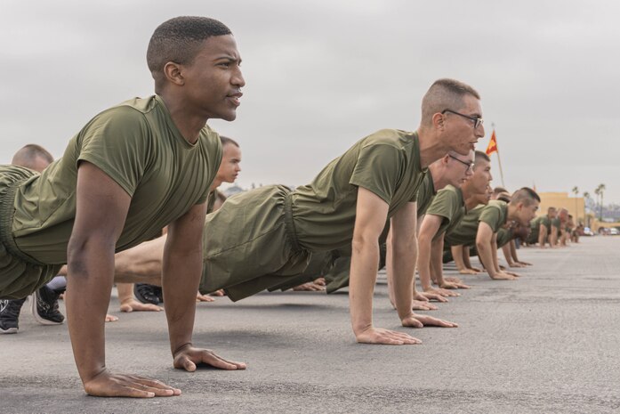 New U.S Marines with Echo Company, 2nd Recruit Training Battalion, conduct dynamic warm-ups prior to a motivational run at Marine Corps Recruit Depot San Diego, California, June 27, 2024. The company motivational run is a three-mile cadence run conducted around the Depot, the last physical training event the Marines will conduct before they graduate from MCRD San Diego, and the first time their friends and families will see their newly transformed U.S. Marines. (U.S. Marine Corps photo by Lance Cpl. Alexandra M. Earl)