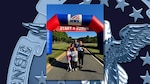 Group photo of family posing with run walk participation medals
