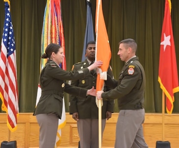 Cyber Center of Excellence Commanding General Maj. Gen. Paul Stanton passes the unit guidon to Col. Julia Donley, 43rd Chief of Signal, as Sgt. Maj. Linwood Barrett, Command Sergeant Major, watches.