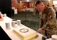 Col. John J. Hosey Jr cuts the cake after his Change of Command ceremony where he assumed duties as the 6th Chief of Cyber.