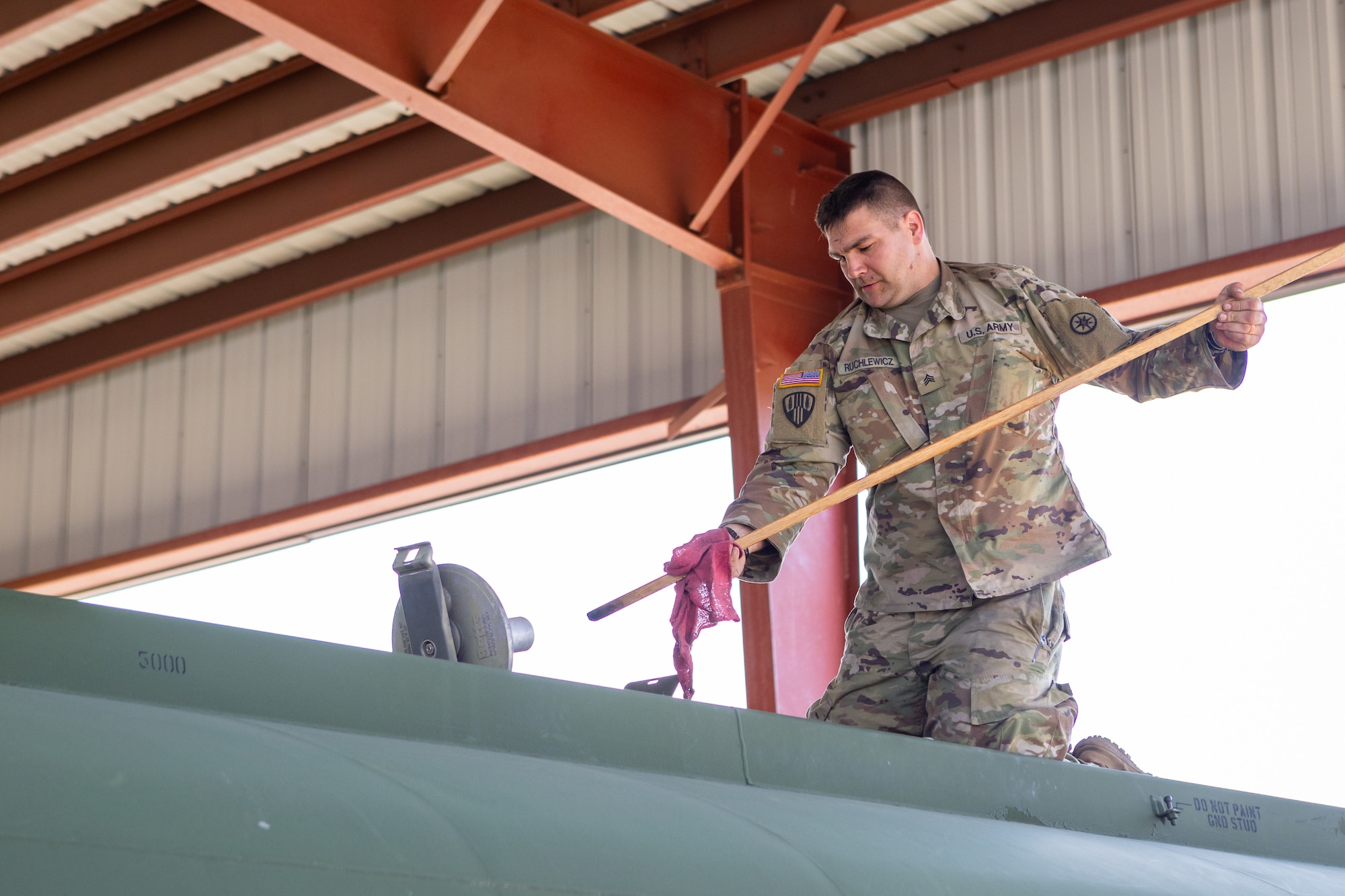 U.S. Army Sgt. Joseph A. Ruchlewicz, 92F petroleum supply specialist assigned to the 298th Transportation Company, Franklin United States Army Reserve Center, Franklin, Pennsylvania, checks the remaining fuel level of an Army fuel tanker with a gauging stick, at the 177th Fighter Wing, Egg Harbor Township, New Jersey, June 12, 2024.