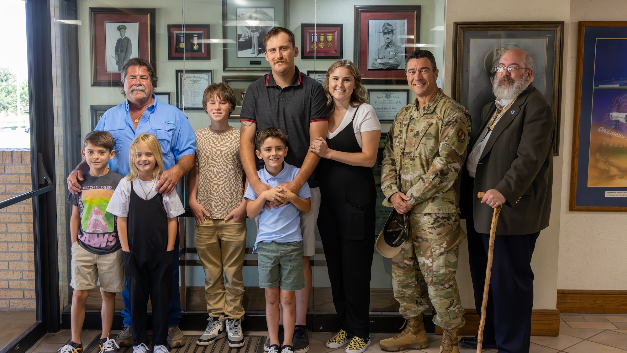 Phil Tinker and family stand in front of display case
