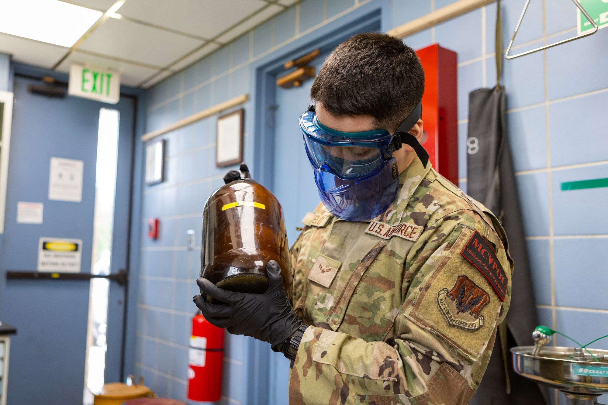 U.S. Air Force Airman 1st Class Gabriel Sotelo, 177th Medical Group commander support staff member and one of 177th Logistics Readiness Squadron Petroleum, Oil, and Lubricants Flight's Multi-Capable Airmen class graduates, shakes a glass container filled with Jet A with Additives (JAA) fuel for test sampling, at the 177th Fighter Wing, Egg Harbor Township, New Jersey, June 12, 2024.