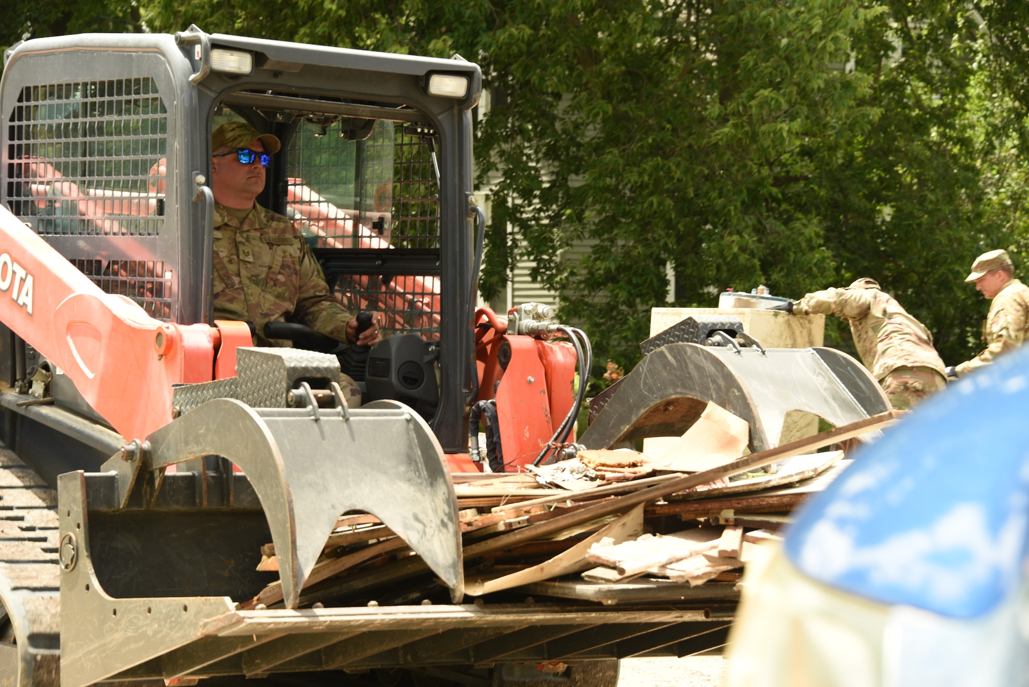 Tech. Sgt. Marcus Roupe, a 185th Air Refueling Wing Civil Engineering Squadron Water and Fuel Systems Maintenance specialist, picks up debris using a skid steer loader