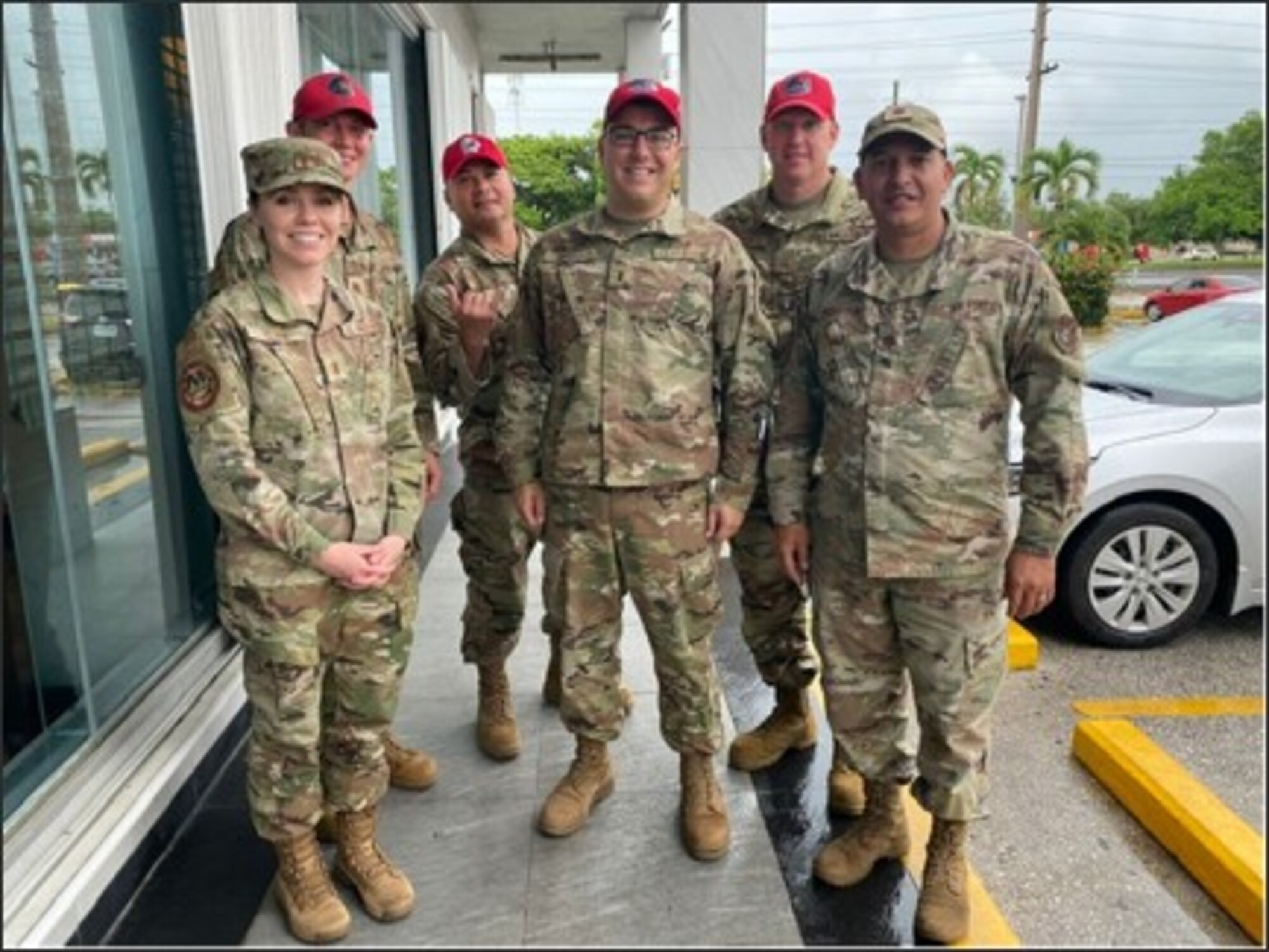 Lt. Rachel Clark, left, takes a group photo alongside the Red Horse Team while temporarily assigned together in Guam.