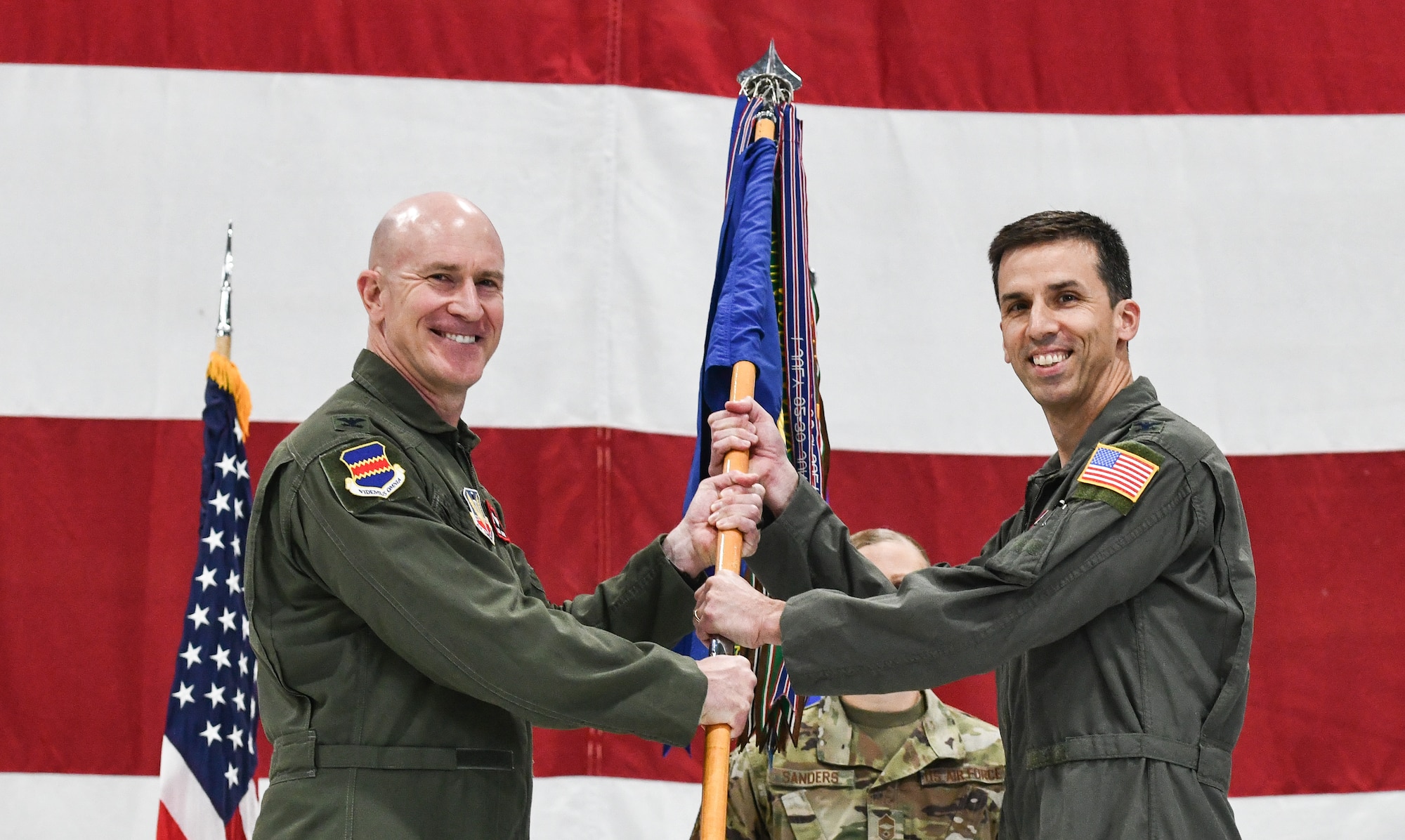 Two Colonels hold a guidon