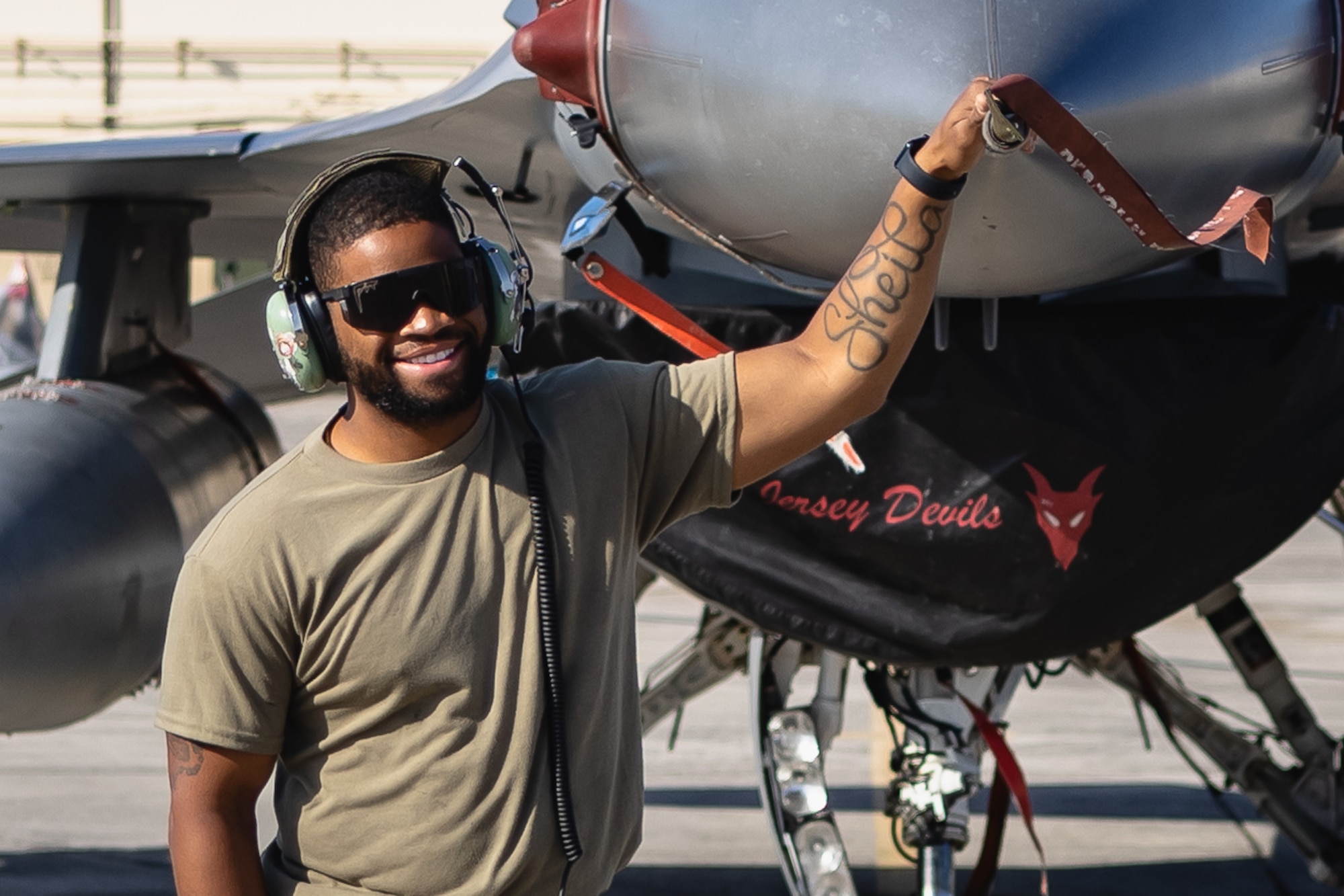 U.S. Air Force Staff Sgt. Shawn Brown, 177th Aircraft Maintenance Squadron crew chief, poses for a photograph in front of an F-16 Fighting Falcon fighter jet from the 177th Fighter Wing, New Jersey Air National Guard, at Joint Base Pearl Harbor-Hickam, Hawaii, June 5, 2024.