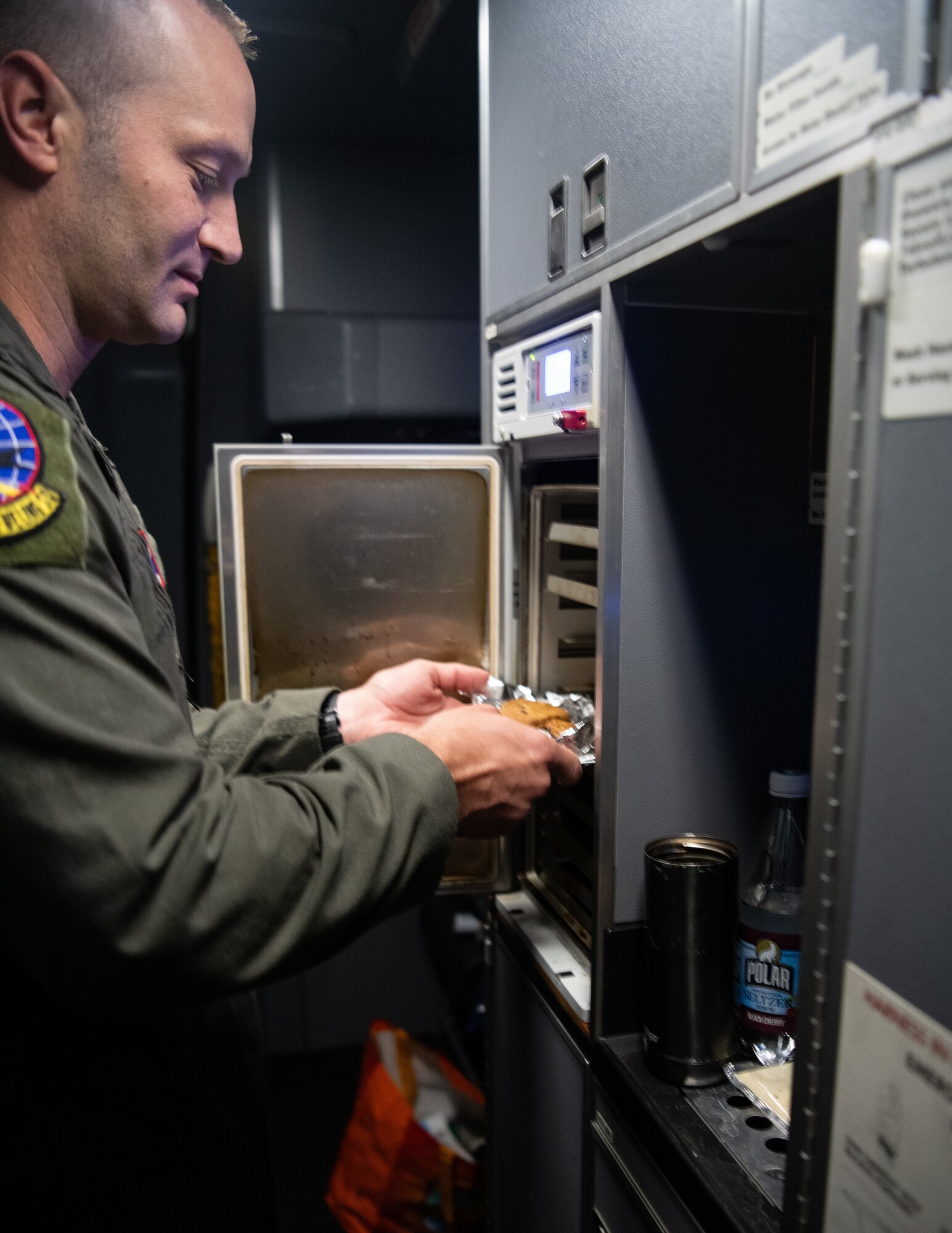 Master Sgt. Jonathan Lauterbach, 349th Air Refueling Squadron instructor boom operator, cooks food inside a KC-46A Pegasus from McConnell Air Force Base, Kansas, that is participating in a Maximum Endurance Flight around the globe called Project Magellan July 1, 2024. Magellan was the world’s first nonstop, KC-46 westbound circumnavigation endurance flight that took off from McConnell June 29 and landed again July 1. (Courtesy Photo)