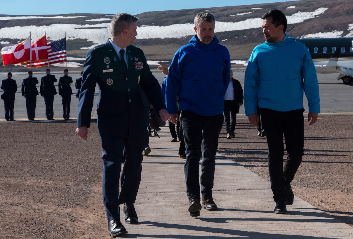 From the left, U.S. Space Force Col. Jason Terry, 821st Space Base Group commander, King Frederik X, King of the Kingdom of Denmark, and Múte Bourup Egede, Prime Minister of Greenland, enjoy a discussion on their way inside after King Frederik X’s arrival to Pituffik Space Base, Greenland. June 29, 2024. King Frederik X made a stop to Pituffik SB while on his way to the village of Qaanaaq. (U.S. Space Force photo by 1st Lt. Danielle Rose)